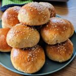 Plate of homemade quick hamburger buns.