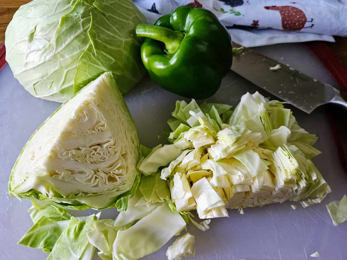 Chopping cabbage and bell pepper for cabbage stew.